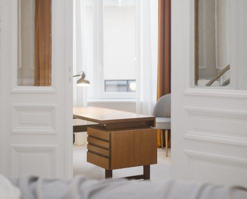 Open doors peeking at wood desk