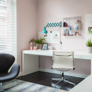 Pink wall with desk next to window