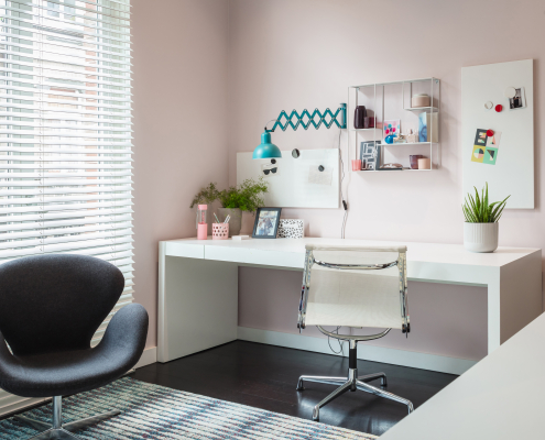 Pink wall with desk next to window